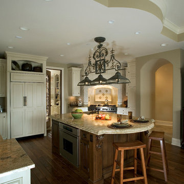 Traditional kitchen with curved tray ceiling to match the curve in the island