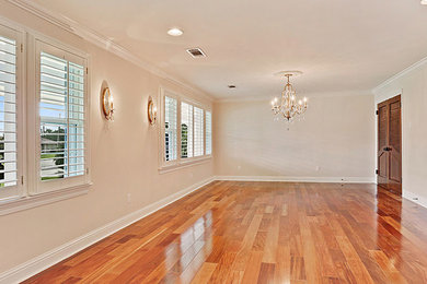 Large elegant medium tone wood floor and brown floor enclosed dining room photo in New Orleans with beige walls and no fireplace