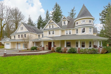 Huge eclectic beige three-story wood exterior home idea in Seattle