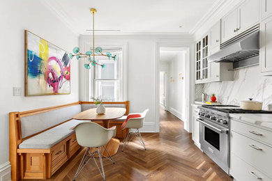 Mid-sized 1950s l-shaped medium tone wood floor and brown floor eat-in kitchen photo in New York with a single-bowl sink, shaker cabinets, gray cabinets, marble countertops, white backsplash, marble backsplash, paneled appliances, no island and white countertops
