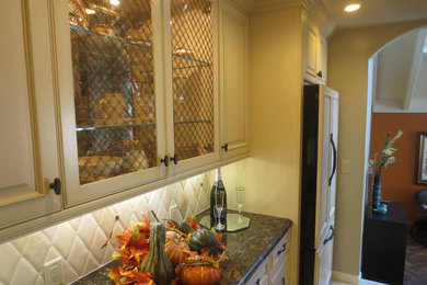 Mid-sized tuscan u-shaped porcelain tile eat-in kitchen photo in San Francisco with a single-bowl sink, glass-front cabinets, white cabinets, quartz countertops, beige backsplash, stone tile backsplash, paneled appliances and an island