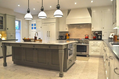 Enclosed kitchen - large traditional l-shaped porcelain tile and beige floor enclosed kitchen idea in Denver with an undermount sink, recessed-panel cabinets, white cabinets, solid surface countertops, beige backsplash, porcelain backsplash, stainless steel appliances and an island