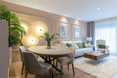 Photo of a small transitional separate dining room in Other with brown walls, laminate floors, brown floor and decorative wall panelling.