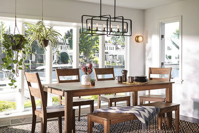 Inspiration for a mid-sized cottage medium tone wood floor and brown floor dining room remodel in Philadelphia with white walls and no fireplace