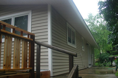 Inspiration for a mid-sized brown one-story vinyl exterior home remodel in Other with a shingle roof