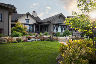 Design ideas for a mid-sized transitional full sun front yard stone landscaping in Denver.