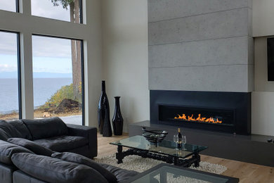 Living room - modern living room idea in Toronto with a concrete fireplace