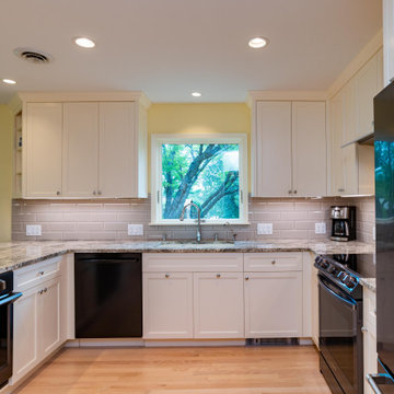 Modern Kitchen With White Painted Shaker Style Cabinets With a Bevel