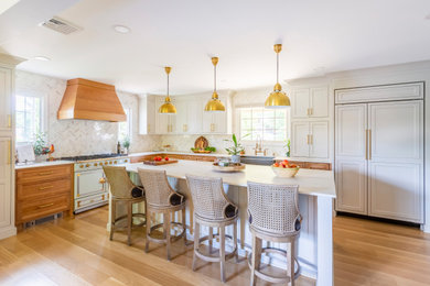 Kitchen pantry - large transitional l-shaped medium tone wood floor and brown floor kitchen pantry idea in New York with a farmhouse sink, shaker cabinets, gray cabinets, white backsplash, marble backsplash, paneled appliances, an island and white countertops