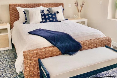 Inspiration for a mid-sized coastal master laminate floor, brown floor and wood ceiling bedroom remodel in Los Angeles with beige walls