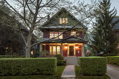 Example of a mid-sized transitional red three-story brick exterior home design in Toronto with a shingle roof