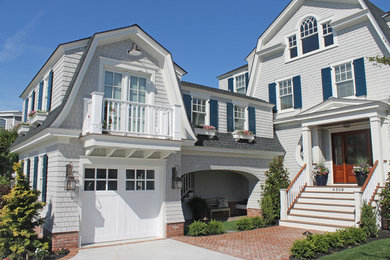 Example of a beach style exterior home design in Philadelphia with a gambrel roof