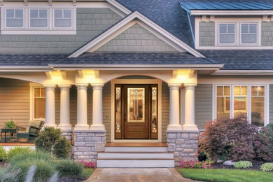 Inspiration for a large contemporary beige two-story wood house exterior remodel in Salt Lake City with a hip roof and a shingle roof
