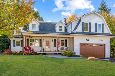 Example of a mid-sized classic white two-story vinyl and clapboard house exterior design in New York with a gambrel roof, a shingle roof and a gray roof