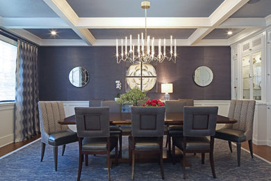 Example of a transitional dark wood floor dining room design in New York with blue walls