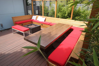 Photo of a mid-sized contemporary backyard deck in Seattle with a fire feature and no cover.