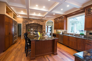 Trendy medium tone wood floor kitchen photo in Other with an undermount sink, raised-panel cabinets, medium tone wood cabinets, granite countertops, multicolored backsplash, ceramic backsplash, stainless steel appliances and an island