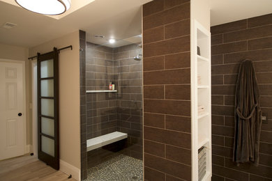 Design ideas for a large contemporary master bathroom in Philadelphia with an undermount sink, recessed-panel cabinets, dark wood cabinets, granite benchtops, a freestanding tub, a curbless shower, gray tile, porcelain tile, grey walls and limestone floors.