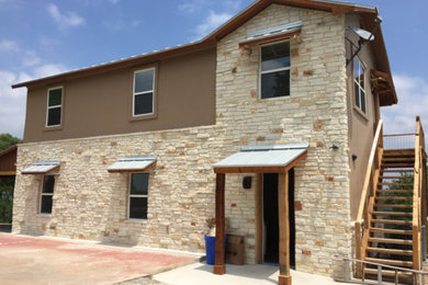 Inspiration for a large craftsman brown two-story mixed siding house exterior remodel in Austin with a hip roof and a metal roof