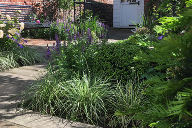 Inspiration for a small traditional courtyard formal partial sun garden in Other with natural stone paving.