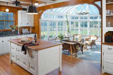 Example of a classic kitchen design in Providence with wood countertops