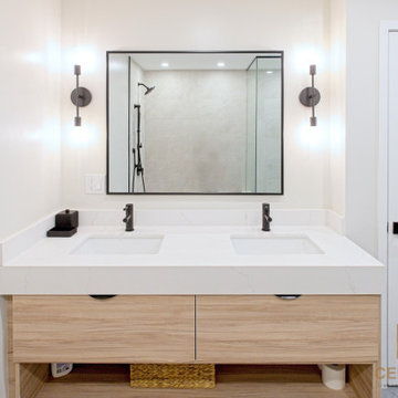Wood Double Vanity with Black Faucets and Twin Wall Sconces | Downtown Toronto