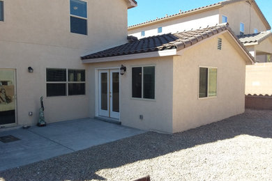 Example of a large classic beige two-story stucco exterior home design with a tile roof