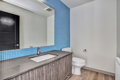 Example of a minimalist bathroom design in Seattle with flat-panel cabinets