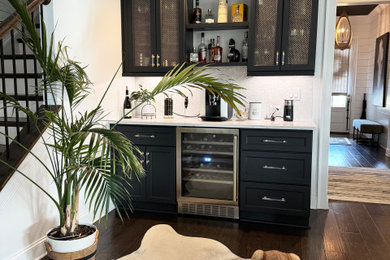 Home bar - contemporary home bar idea in Atlanta with raised-panel cabinets and white countertops