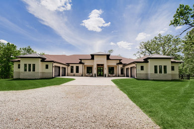 Example of a large transitional two-story brick house exterior design in Other with a brown roof