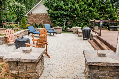 Patio - large craftsman backyard stone patio idea in Charlotte