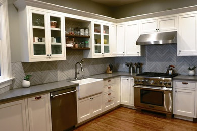 Trendy light wood floor eat-in kitchen photo in San Francisco with a farmhouse sink, shaker cabinets, white cabinets, quartzite countertops, beige backsplash, porcelain backsplash, stainless steel appliances and no island