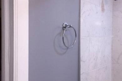 Mid-sized white tile and ceramic tile ceramic tile and white floor tub/shower combo photo in New York with a one-piece toilet, gray walls and white countertops