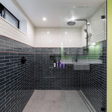 Spacious Walk-In Shower with Two-Tone Subway Tile and Matte Black Fixtures