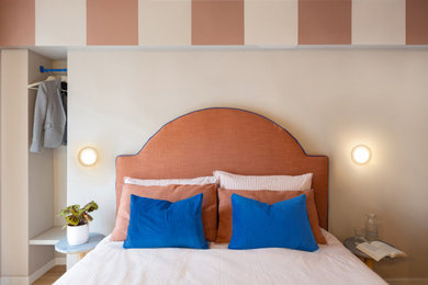Inspiration for a small modern porcelain tile and brown floor bedroom remodel in Turin with beige walls