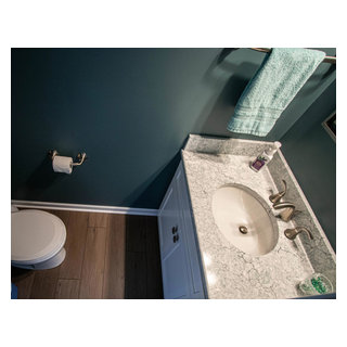 Green Powder Room with White Vanity and Beige and Green Countertop ...