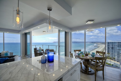 Inspiration for a small coastal galley light wood floor open concept kitchen remodel in San Diego with a single-bowl sink, shaker cabinets, white cabinets, marble countertops, stone slab backsplash, stainless steel appliances and an island