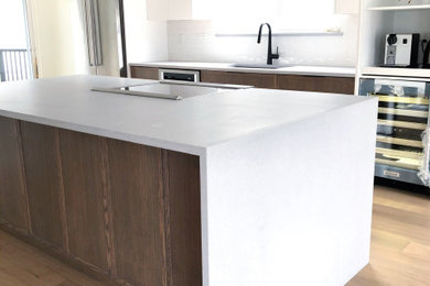 Example of a large trendy single-wall eat-in kitchen design in Vancouver with quartz countertops, an island and gray countertops
