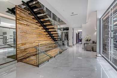 Large transitional marble floor and white floor entryway photo in Vancouver with multicolored walls