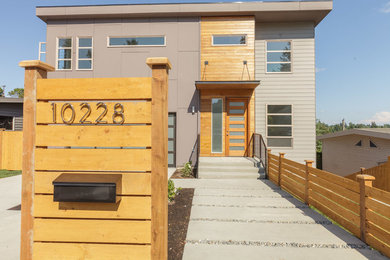 Inspiration for a modern three-storey exterior in Seattle with mixed siding.