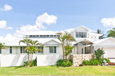 Beach style two-storey white house exterior in Gold Coast - Tweed with a gable roof.