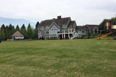 Inspiration for a large timeless gray three-story wood gable roof remodel in Minneapolis