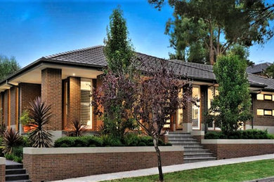 Inspiration for a medium sized and brown contemporary bungalow brick detached house in Melbourne with a hip roof and a tiled roof.