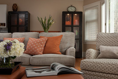 Example of a large transitional enclosed medium tone wood floor family room design in San Francisco with beige walls, no fireplace and no tv