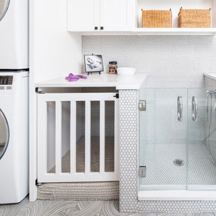 Inspiration for a medium sized modern utility room in Chicago with flat-panel cabinets, white cabinets, engineered stone countertops, porcelain flooring, a stacked washer and dryer, grey floors and white worktops.