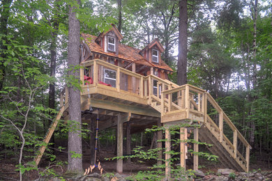 Example of a mountain style brown one-story wood exterior home design in Philadelphia with a tile roof