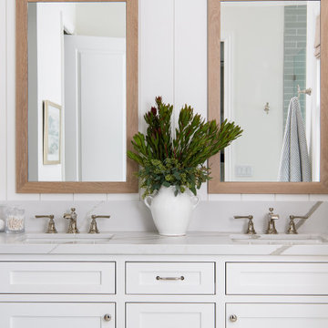 A custom-built vanity with shaker style cabinets in a simple white