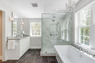 Example of a mid-sized mid-century modern master gray tile and marble tile porcelain tile, gray floor and single-sink bathroom design in Richmond with flat-panel cabinets, white cabinets, gray walls, an undermount sink, granite countertops, a hinged shower door, white countertops, a niche and a built-in vanity