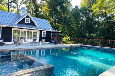 Example of a large trendy backyard stone and rectangular pool landscaping design in New York
