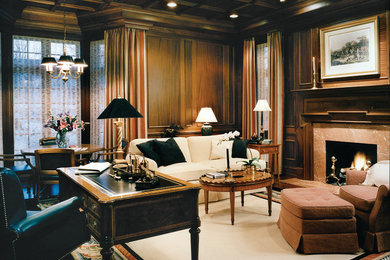 Large traditional home office in Detroit with brown walls, dark hardwood floors, a standard fireplace, a stone fireplace surround, a freestanding desk and white floor.